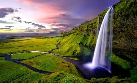 Icelandic waterfall seen on a road trip in a hire car covered with car hire excess insurance which includes volcanic ash cover