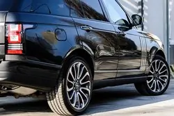 side view of black car showing wheels, tyres and wing mirror which can be covered by a car hire excess insurance policy