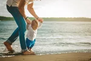 father and son enjoying time on the beach because they have a cheap car rental and car hire excess insurance