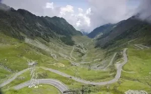 a winding road in romania which is a perfect road trip with a car hire from bucharest airport