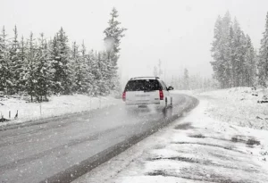 rental car protected by car hire excess insurance being driven along snowy road