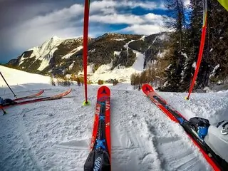 skis and poles on snow slope