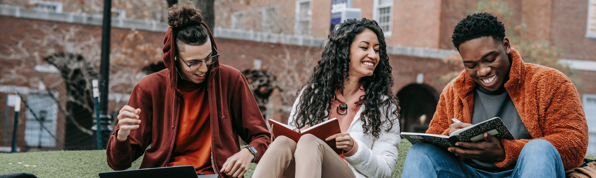 group of three students sitting reading